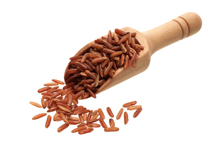 Food ingredients: heap of red rice in a wooden scoop, on white backgroundの写真素材