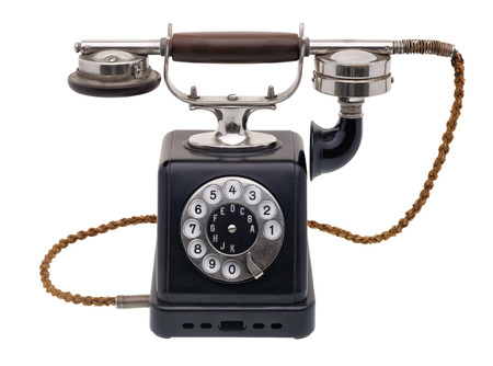 Isolated objects: one antique black telephone, very old and aged, isolated on white backgroundの写真素材