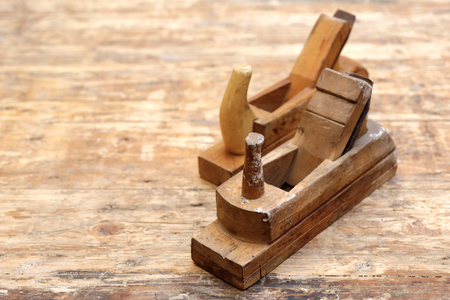 Backgrounds and textures: two old carpenter's planes on a wooden workbenchの写真素材