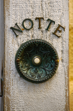 Antique door bell button, aged and rustyの写真素材