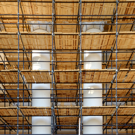 Backgrounds and textures: scaffoldings around old building, restoration works in progress