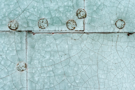 Backgrounds and textures: old painted riveted metal door close-up shotの写真素材