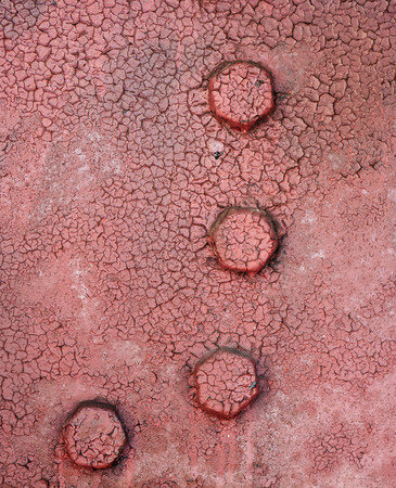 Backgrounds and textures: cracked paint metal surface with riveted joints, industrial abstractの写真素材