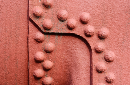 Backgrounds and textures: old painted metal wall surface with riveted joints, industrial abstractの写真素材