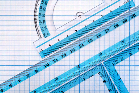 Backgrounds and textures: group of transparent plastic rulers, arranged on graph paper, educational abstractの写真素材