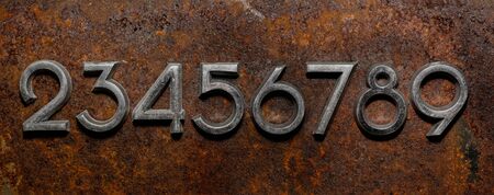 Backgrounds and textures: assorted metal cyrillic digits on a rusty background, typographic art...