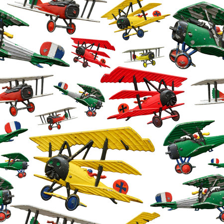 Assorted set of generic vintage First World War toy airplanes, various colors, isolated on white background, seamless patternの写真素材