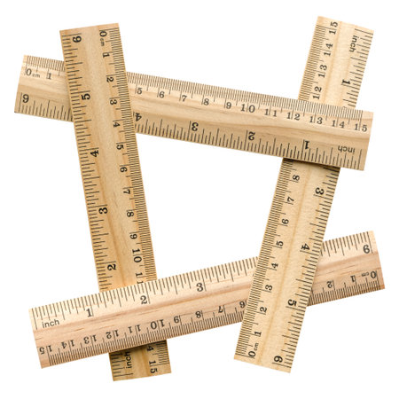 Group of four wooden rulers, arranged as four-sided figure, isolated on white background