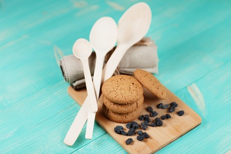 Composition of tasty biscuits and raisins over vintage wooden table.の写真素材