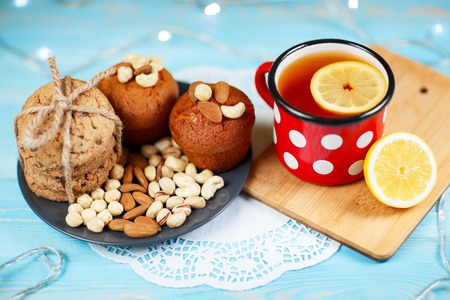 Composition of biscuits, cup of tea and lemon on the vintage background.の写真素材