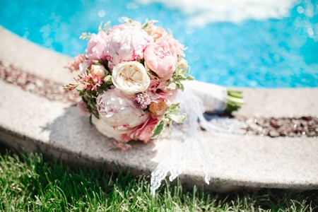 Wedding bouquet of white and rose flowers on the floor.の写真素材