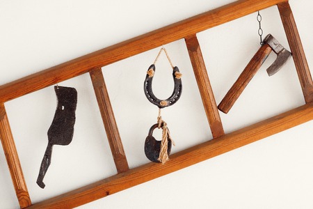 Traditional old metal tools exposed over wall.の写真素材