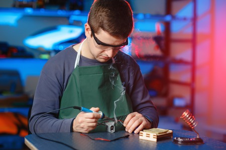 Young Male Engineer or Technician Repair Soldering Drone Details.の写真素材