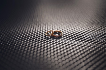 Two Golden Wedding Rings. Bride and Groom. Love concept.の写真素材