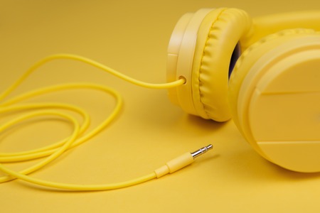 Yellow headphones on yellow background. Music concept.の写真素材