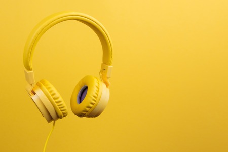 Yellow headphones on yellow background. Music concept.の写真素材