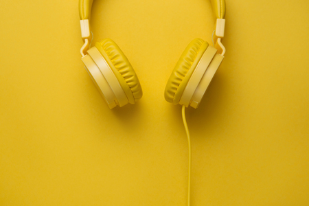 Yellow headphones on yellow background. Music concept.の写真素材