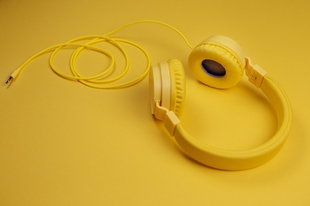 Yellow headphones on yellow background. Music concept.の写真素材
