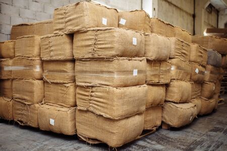 Photo of dried tobacco leaves in cloth sack for cigarette industry.の写真素材