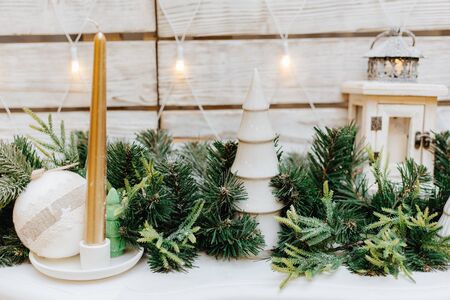 Christmas festive decoration with candles, garlands and fir tree.の写真素材