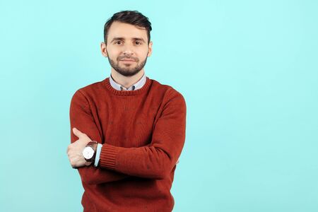 Confident bearded young man in casual outfit on cyan background.の写真素材