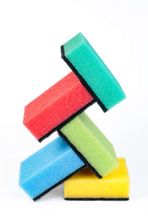 Photo of colorful dishwashing sponge stack on white background.