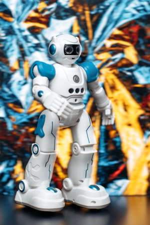 Photo of humanoid robot walking and dancing in nenon light background.の写真素材