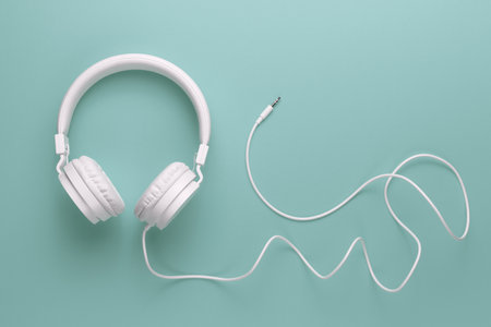 Modern white headphone on cyan background. Music concept.の写真素材