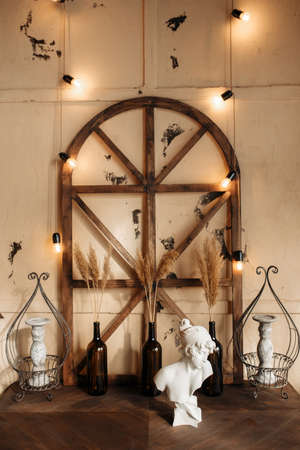Beautiful vintage home design with lights on wall, wine botles, cement sculpture, old wooden table...