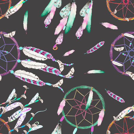 Seamless pattern with dreamcatchers and feathers in the air, hand drawn in watercolor on a dark backgroundの写真素材