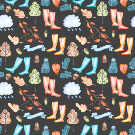 Seamless pattern with watercolor autumn objects (warm hat and mittens, rubber boots, rain cloud, dry tree leaves and other), hand drawn isolated on a dark backgroundの写真素材