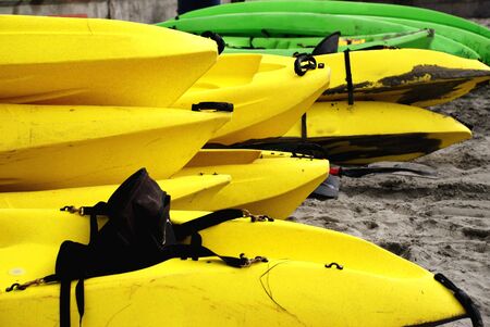 Yellow and Green Sea Kayaks on Beachの写真素材