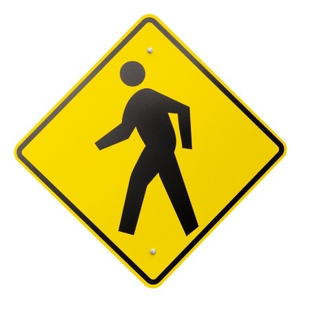 A yellow safety or warning sign for pedestrians walking isolated on a white backgroundの写真素材