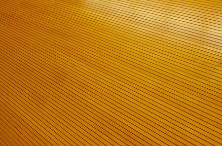 Rows of tightly fitted wooden slats form disappear into infinity with reflections of light