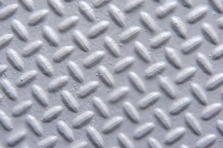 Background of painted metal with raised herringbone patternの写真素材