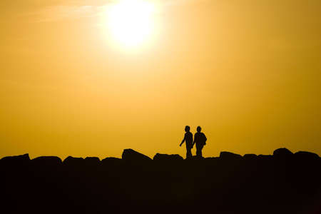 Silhouettes of the walking together coupleの写真素材