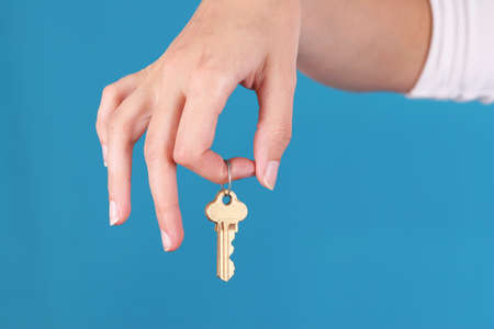 Hand is holding keys on the keyringの写真素材