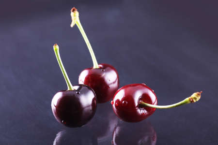 Three juicy fresh cherriesの写真素材