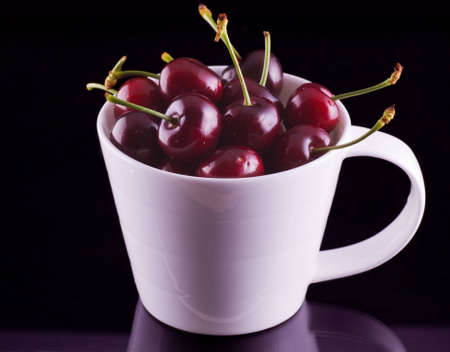 Red fresh cherries in the bowlの写真素材