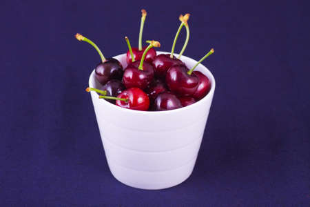 Red fresh cherries in the bowlの写真素材