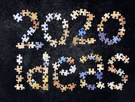 Background texture: ideas for 2020. The inscription from the puzzles Ideas, on a black background....
