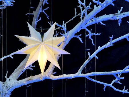 New Year decorations in the house. Christmas star and multi-colored garlands. Holiday toys for the...