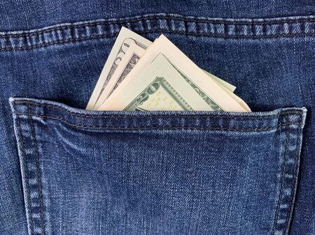 Dollars in the back pocket of men's jeans. Banknotes of American money in blue jeans. American...