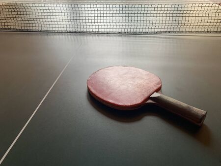 tennis table rackets on the tennis table. Racket for table tennis on a grid background. Concept: table sport.の写真素材