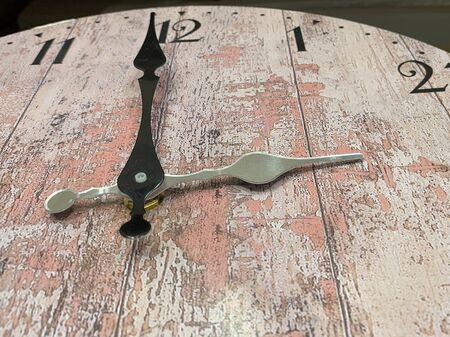 Dial with arrows on an old watch, close-up. Antique clock with a big and small arrow. Concept: the...