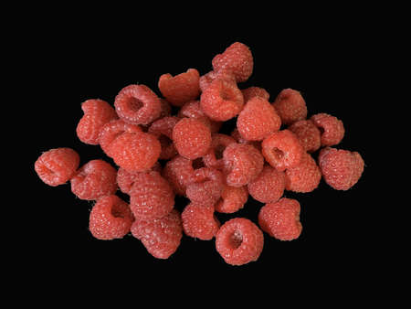 Background texture: red raspberries on a black background. Ripe raspberries, close-up. Concept:...