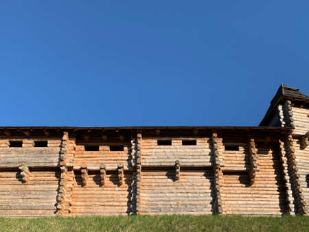 Wooden fortress wall against the sky. Medieval fortress with high walls. Wooden installation in the style of an ancient city. Park "Kievan Rus" Kiev region, Obukhov district, village Kopachevo, May 10, 2021.の写真素材