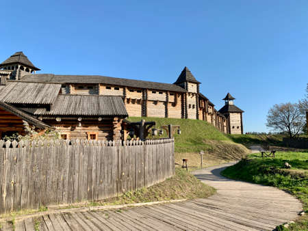Wooden fortress wall against the sky. Medieval fortress with high walls. Wooden installation in the style of an ancient city. Park "Kievan Rus" Kiev region, Obukhov district, village Kopachevo, May 10, 2021.の写真素材
