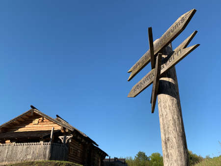 Wooden post with many pointers against the sky. There are different signs at the crossroads. There is a signpost for travelers at the crossroads.の写真素材