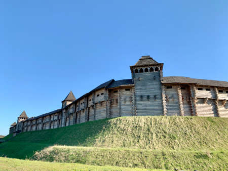 Wooden fortress wall against the sky. Medieval fortress with high walls. Wooden installation in the style of an ancient city. Park "Kievan Rus" Kiev region, Obukhov district, village Kopachevo, May 10, 2021.の写真素材